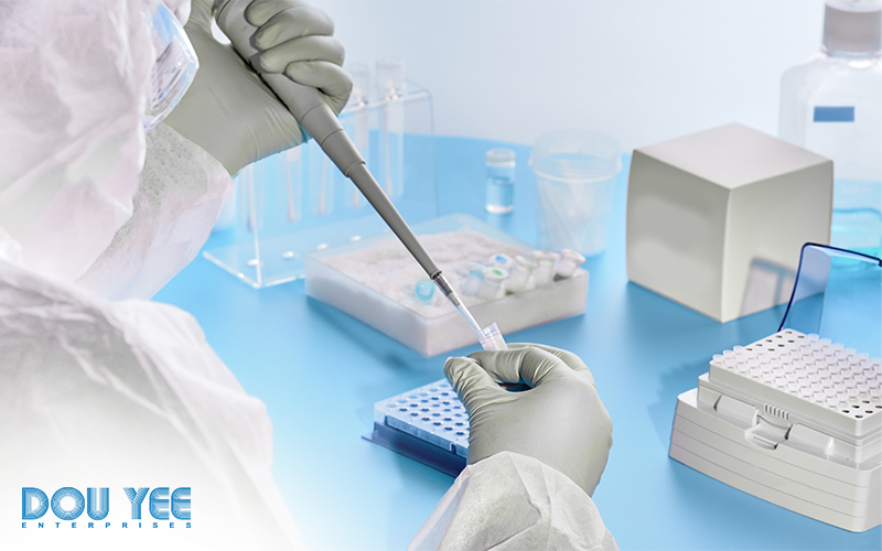 Epidemiologist in protective suit, mask, and glasses working with swabs